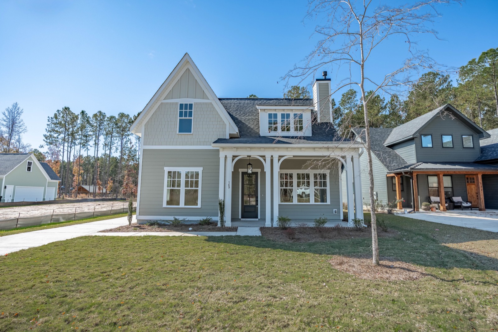 169 Timber Trail Lane, a blue farmhouse with a deep front porch