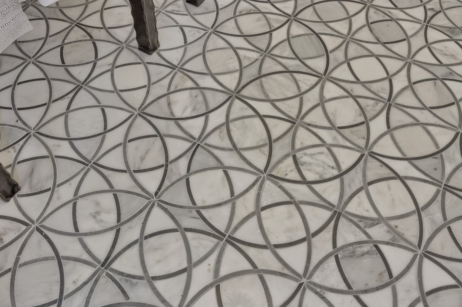 A marble mosaic floor laid in a pattern of interlocking circles