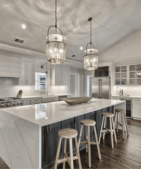 Springlake modern kitchen with white cabinetry and marble island for elegant living.